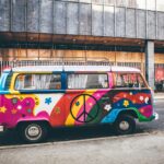 multicolored minivan parked on roadside near building