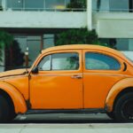 shallow focus photography of orange Volkswagen Beetle