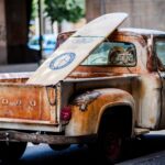 vintage brown and white Ford single-cab pickup truck parked on pavements